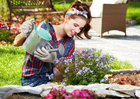 Accessible gardener reviewing a maintenance checklist in a Purley garden