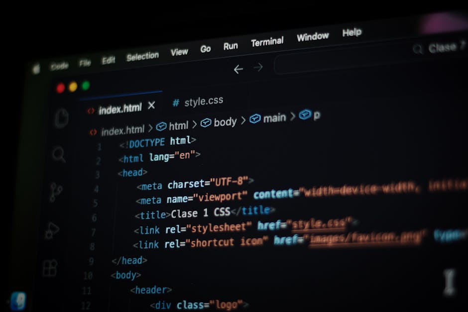 A close-up view of a computer screen displaying HTML coding, featuring lines of code with tags such as <html>, <head>, <title>, and <body>, in a dark-themed code editor. The co